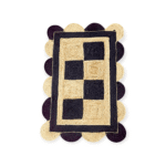 Close-up of eco-friendly jute rug’s scalloped border and rustic weave, styled with linen cushions and rattan furniture